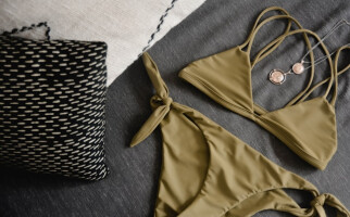 green swimsuit and gold jewellery