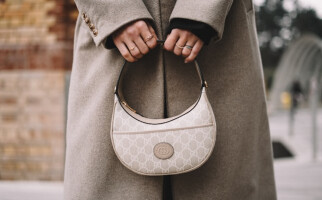 woman holding a gucci purse