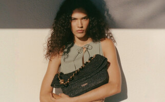 woman holding a black loewe bag