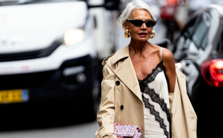 woman wearing a white dress and beige coat
