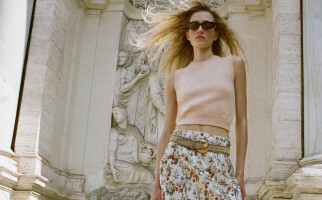 Woman wearing a pink top and printed skirt