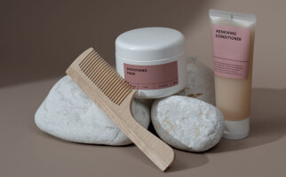 Various hair products displayed with rocks