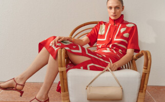 Woman wearing a red printed dress sitting