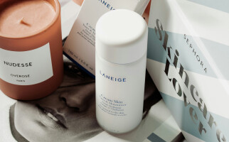 Skincare and candle on book