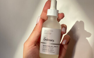 Person holding a skincare product from The Ordinary
