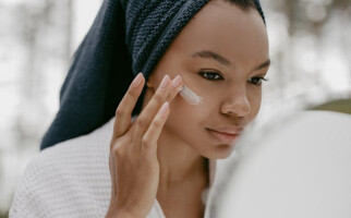 Woman applying a skincare product on her face