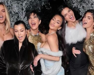 from left to right, Khloe Kardashian, Kourtney Kardashian, Kris Jenner, Kim Kardashian, Kendall Jenner and Kylie Jenner pose in gowns against a white christmas tree.